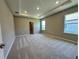 Spacious primary bedroom boasts plush carpeting, recessed lighting and plenty of natural light at 4009 Maggie Loop, Lakeland, FL 33813