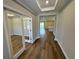 Inviting entryway with stylish wood flooring and views of the open-concept living spaces at 4015 Maggie Loop, Lakeland, FL 33813