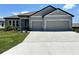 Charming single-story home with a well-maintained lawn and a spacious two-car garage at 4015 Maggie Loop, Lakeland, FL 33813