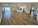 Spacious living room with modern flooring, flowing into the kitchen with a central island at 4015 Maggie Loop, Lakeland, FL 33813