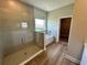Luxurious main bathroom with a tiled shower, separate tub, and a view from the window at 4015 Maggie Loop, Lakeland, FL 33813