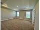 Serene main bedroom boasting plush carpeting and a tray ceiling with recessed lighting at 4015 Maggie Loop, Lakeland, FL 33813