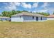 View of the back of the house featuring a sliding door to the backyard with ample lawn space at 4126 Sw 132Nd Ln, Ocala, FL 34473