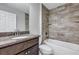 Bathroom showcasing the modern vanity and a shower-tub combo with beautiful tile work at 4126 Sw 132Nd Ln, Ocala, FL 34473