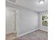Bright bedroom with neutral carpet, white trim, and a view of the neighborhood at 4126 Sw 132Nd Ln, Ocala, FL 34473