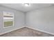 Bedroom with neutral walls, plush carpet and a window with blinds at 4126 Sw 132Nd Ln, Ocala, FL 34473