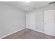 Bedroom with neutral walls, plush carpet, double-door closet and door at 4126 Sw 132Nd Ln, Ocala, FL 34473