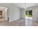 Bright dining area with tile floors, access to the backyard, and stylish chandelier at 4126 Sw 132Nd Ln, Ocala, FL 34473