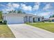 Charming single-story home featuring a two-car garage, well-maintained lawn, and beautiful landscaping at 4126 Sw 132Nd Ln, Ocala, FL 34473