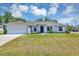 Charming single-story home featuring a two-car garage, well-maintained lawn, and beautiful landscaping at 4126 Sw 132Nd Ln, Ocala, FL 34473