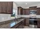 A close up of a kitchen showcasing granite counters and stainless steel appliances at 4126 Sw 132Nd Ln, Ocala, FL 34473