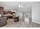 Open floor plan kitchen with dark wood cabinetry, stainless steel appliances, and granite countertops at 4126 Sw 132Nd Ln, Ocala, FL 34473