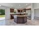 Kitchen featuring dark wood cabinetry, stainless steel appliances, granite countertops, and tile flooring at 4126 Sw 132Nd Ln, Ocala, FL 34473