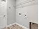 Functional laundry room with hookups and a wire rack shelf at 4126 Sw 132Nd Ln, Ocala, FL 34473