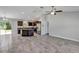Open concept living area with tile floors and access to the kitchen and a sliding door to the backyard at 4126 Sw 132Nd Ln, Ocala, FL 34473