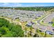 High-angle view of a modern housing community, highlighting the numerous homes and organized street design from above at 4485 Renly Ln, Clermont, FL 34711