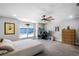 Spacious bedroom featuring a ceiling fan, carpet flooring, neutral walls, and large windows for plenty of natural light at 4485 Renly Ln, Clermont, FL 34711