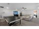 Spacious living room featuring a ping pong table, sofa, cat tree, and flat screen TV at 4485 Renly Ln, Clermont, FL 34711