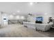 Spacious living room with a gray sofa, ping pong table, flat screen TV, and a cat tree at 4485 Renly Ln, Clermont, FL 34711