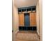 Mudroom featuring custom millwork in navy and natural wood tones, and decorative baskets at 4485 Renly Ln, Clermont, FL 34711