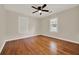 Bedroom featuring hardwood floors, fan, neutral paint, and two windows at 508 10Th St, St Cloud, FL 34769