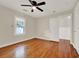Bright bedroom featuring hardwood floors, neutral paint, ceiling fan and one window at 508 10Th St, St Cloud, FL 34769