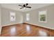 A bright, airy bedroom with hardwood floors, three windows, and ceiling fan at 508 10Th St, St Cloud, FL 34769