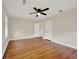 Spacious bedroom featuring hardwood floors, ceiling fan, and neutral paint, with two doorways at 508 10Th St, St Cloud, FL 34769