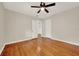 Spacious bedroom with hardwood floors, ceiling fan, and two doorways leading to closets at 508 10Th St, St Cloud, FL 34769