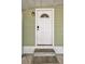 Close-up of the white front door with glass and modern electronic lock at 508 10Th St, St Cloud, FL 34769