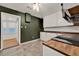 Kitchen with dark accent wall, white cabinets, wood countertops, tile backsplash, and stainless steel range at 508 10Th St, St Cloud, FL 34769