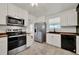 Bright kitchen features white cabinets, stainless steel appliances, subway tile backsplash and butcher block countertops at 508 10Th St, St Cloud, FL 34769
