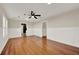 Living room boasting hardwood floors, traditional wainscoting, and a ceiling fan at 508 10Th St, St Cloud, FL 34769