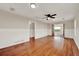 Spacious living room with hardwood floors, classic wainscoting and a ceiling fan at 508 10Th St, St Cloud, FL 34769