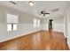 Bright living room with hardwood floors and double hung windows with pleated shades at 508 10Th St, St Cloud, FL 34769