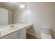 Bright bathroom featuring a large mirror, white cabinets, and a toilet at 50989 Highway 27 # 371, Davenport, FL 33897