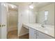 Well-lit bathroom with a large mirror, white sink, and separate shower area at 50989 Highway 27 # 371, Davenport, FL 33897