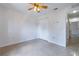 Clean bedroom featuring tiled flooring, a ceiling fan, and a double-door closet for ample storage at 50989 Highway 27 # 371, Davenport, FL 33897