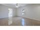 Spacious bedroom with neutral tile flooring, ceiling fan, and a window at 50989 Highway 27 # 371, Davenport, FL 33897