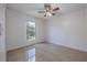 Cozy bedroom with tiled flooring, a ceiling fan, and a window overlooking the yard at 50989 Highway 27 # 371, Davenport, FL 33897
