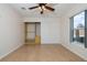 Bedroom featuring tile floors, a ceiling fan, closet, and a window at 50989 Highway 27 # 371, Davenport, FL 33897