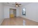 Bedroom featuring tile floors, a ceiling fan, and a closet at 50989 Highway 27 # 371, Davenport, FL 33897