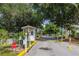 Community entrance gatehouse surrounded by trees, providing security and a welcoming feel at 50989 Highway 27 # 371, Davenport, FL 33897