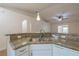 Bright kitchen featuring granite countertops and stainless steel sink, opening to the living area at 50989 Highway 27 # 371, Davenport, FL 33897