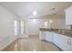 Bright kitchen with white cabinets, granite countertops, stainless appliances, and seamless flow to the living area at 50989 Highway 27 # 371, Davenport, FL 33897