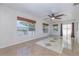 Inviting living room with tile floors, ceiling fan, and multiple windows that offer a bright atmosphere at 50989 Highway 27 # 371, Davenport, FL 33897
