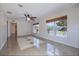 Bright living room featuring stylish tile flooring, ceiling fan, and natural light through large windows at 50989 Highway 27 # 371, Davenport, FL 33897