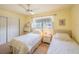 Bright bedroom featuring two beds, closet, window, and neutral carpet at 5505 Hernandes Dr # 204, Orlando, FL 32808