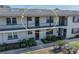 Well-maintained condo with balconies and neatly trimmed bushes around the front entrances at 5505 Hernandes Dr # 204, Orlando, FL 32808