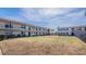 Charming condo buildings with a large, well-maintained lawn under a sunny sky at 5505 Hernandes Dr # 204, Orlando, FL 32808